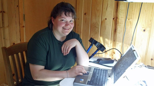 Lucinda, AB8WF, at the notebook computer.