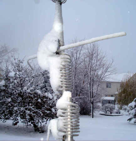 Snow covers the coils on a Butternut vertical antenna.