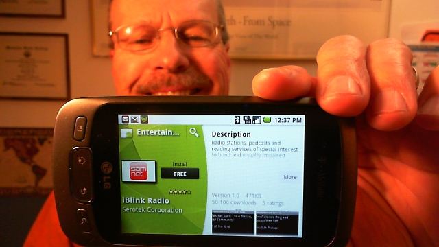 Pat, WA0TDA, holds up Android phone showing free iBlink Radio application in the Android Market. 