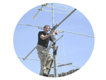 Dr. Dave, KN0S, climbs the antenna tower at Radio Camp.