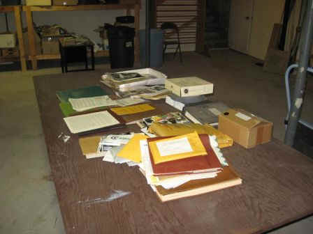 Big table in George's basement, filled with handiham history stuff.