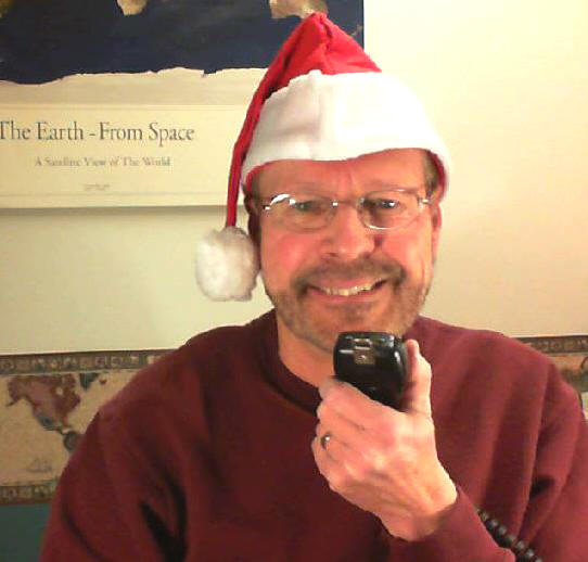 Pat with microphone & Santa hat