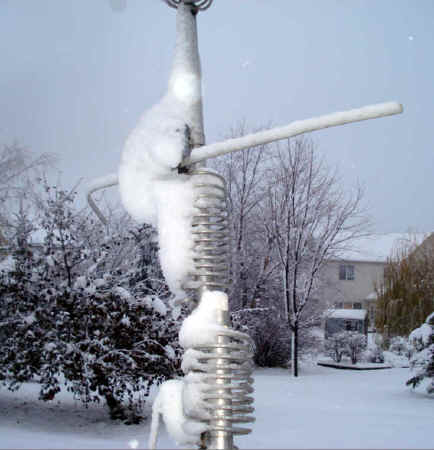 Butternut vertical antenna covered with a wintery coat of fluffy, white snow.