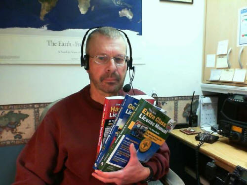 Pat, WA0TDA, holds three license manuals.